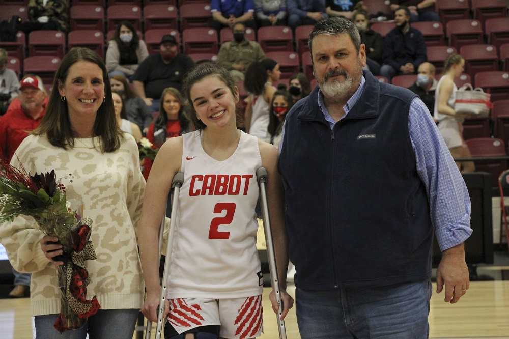 Girls Basketball senior with parents being recognized for senior night 2021